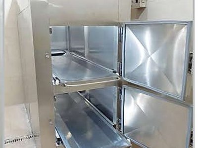 Mortuary Refrigerator — Two Cells, both doors open with body trays extended, indicator lights on top panel