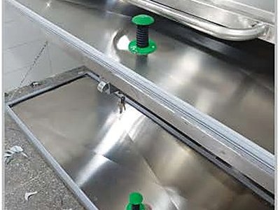 Mortuary Refrigerator — Two Cells, close-up of stainless steel body trays and roller guides
