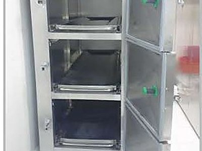 Mortuary Refrigerator — Three Cells, front view with all three doors open and body trays inside