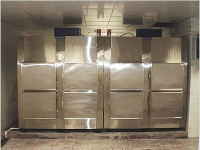 Mortuary Refrigerator — Six Cells, front view with all doors closed, installed in a morgue room